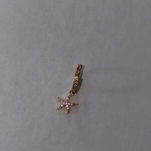 One gold tone starfish earring with pavè gemstone design (this is a single)
